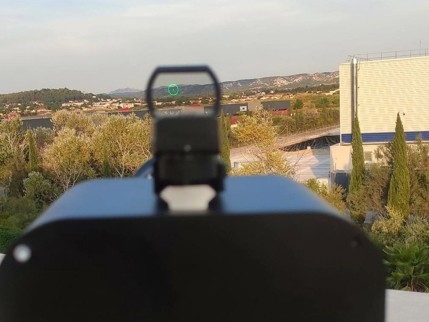 The green-dot sight lines the operator up on a target before the optics take over.